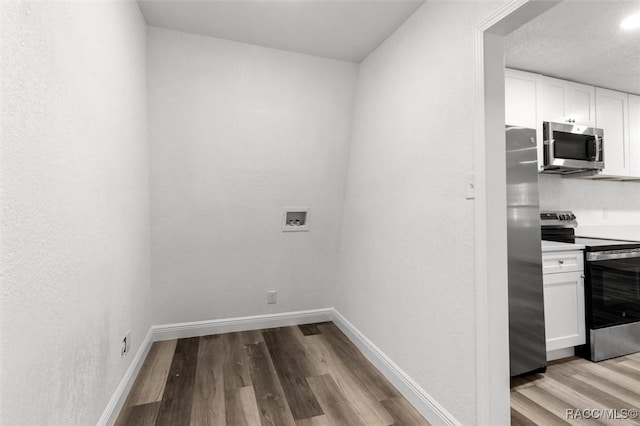 383 S Rooks Ave, Inverness, FL 34453 - laundry room featuring hookup for a washing machine, baseboards, laundry area, and wood finished floors