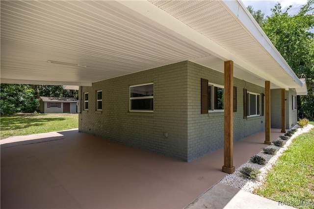 1361 NW 19th St, Crystal River, FL 34428 - view of home's exterior with brick siding, an attached carport, and an outbuilding