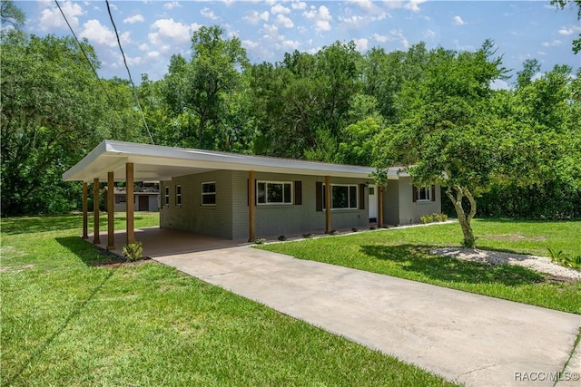 1361 NW 19th St, Crystal River, FL 34428 - ranch-style home featuring concrete driveway, a front lawn, a carport, and brick siding