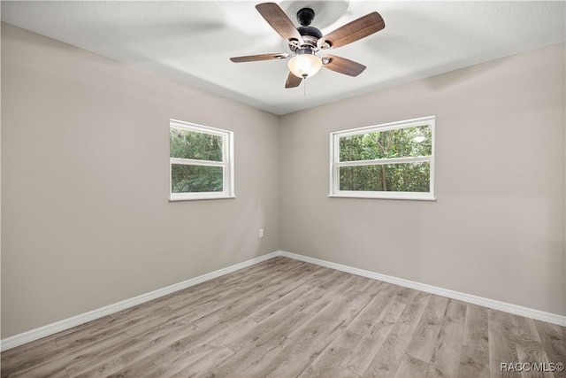 1361 NW 19th St, Crystal River, FL 34428 - empty room with healthy amount of natural light, light wood finished floors, and ceiling fan