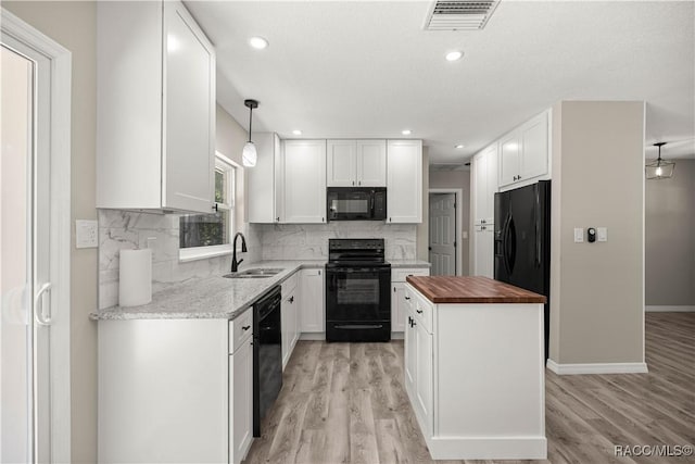 1361 NW 19th St, Crystal River, FL 34428 - kitchen featuring black appliances, wood counters, white cabinetry, light wood-type flooring, and recessed lighting
