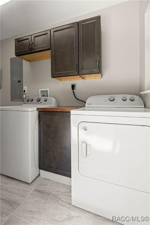 1361 NW 19th St, Crystal River, FL 34428 - laundry area with electric panel, cabinet space, washer and clothes dryer, and a textured ceiling