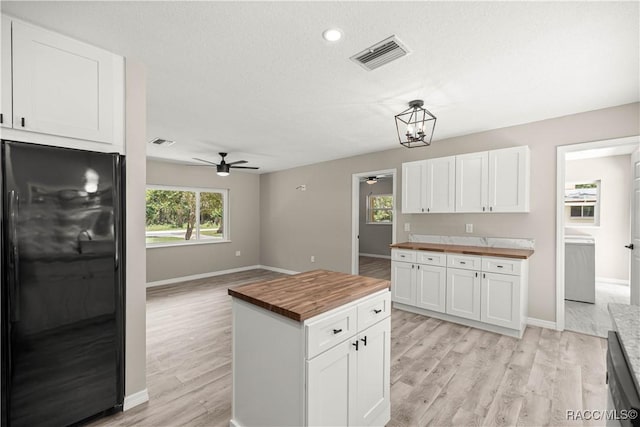 1361 NW 19th St, Crystal River, FL 34428 - kitchen with wood counters, fridge, a ceiling fan, light wood-style floors, and white cabinets