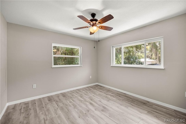 1361 NW 19th St, Crystal River, FL 34428 - spare room featuring plenty of natural light, wood finished floors, and a ceiling fan