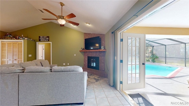 826 E Gaines Ln, Hernando, FL 34442 - living area with a brick fireplace, vaulted ceiling, ceiling fan with notable chandelier, and light tile patterned floors