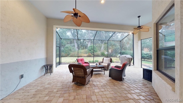 sunroom with a healthy amount of sunlight and ceiling fan