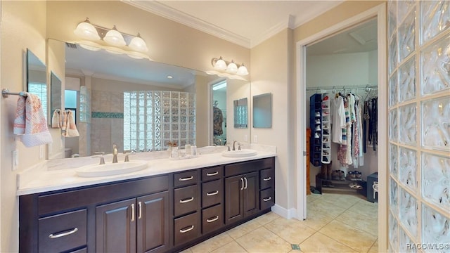 full bathroom featuring crown molding, a walk in closet, a sink, and tile patterned floors