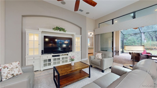 living room featuring ceiling fan and visible vents