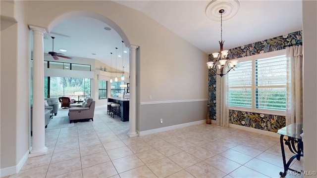 interior space featuring a healthy amount of sunlight, ornate columns, arched walkways, and lofted ceiling