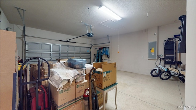 garage featuring electric panel and a garage door opener