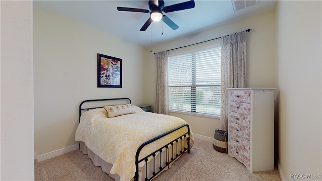 bedroom featuring light carpet, ceiling fan, visible vents, and baseboards