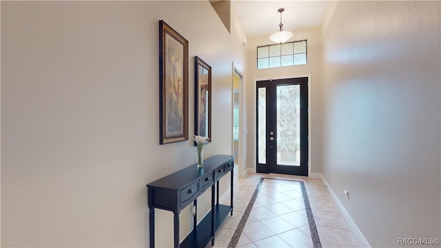 foyer with light tile patterned floors and baseboards