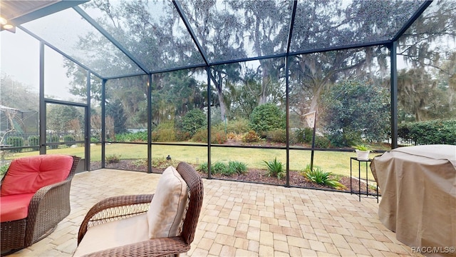 view of patio / terrace featuring glass enclosure and grilling area