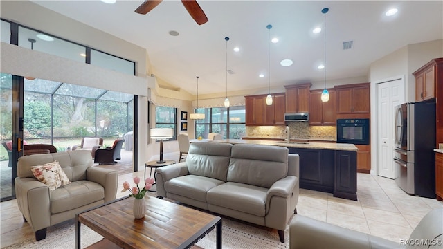 living room with recessed lighting, visible vents, a ceiling fan, light tile patterned flooring, and vaulted ceiling