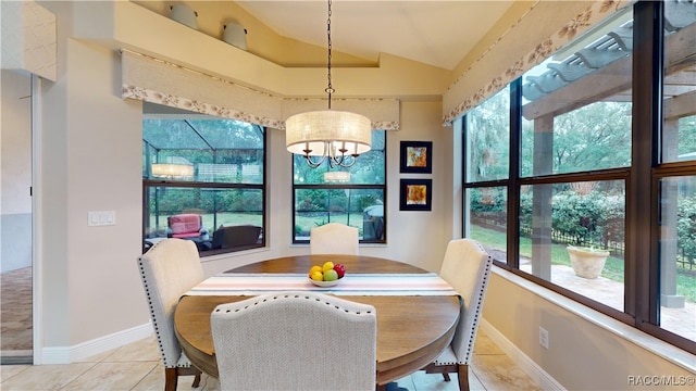 tiled dining area featuring a notable chandelier, vaulted ceiling, and baseboards