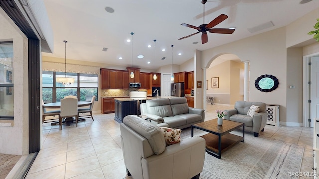 living area featuring arched walkways, ceiling fan, light tile patterned flooring, vaulted ceiling, and recessed lighting