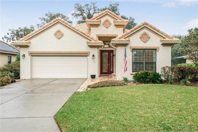 mediterranean / spanish-style home featuring an attached garage, driveway, a tiled roof, and a front yard