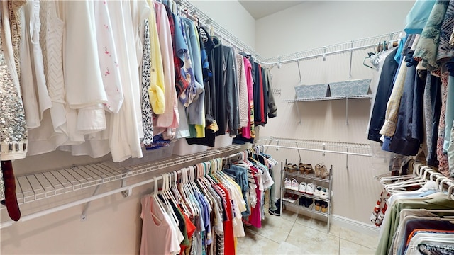 spacious closet featuring light tile patterned flooring