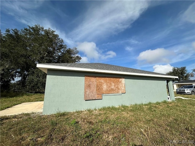 view of side of home featuring a yard