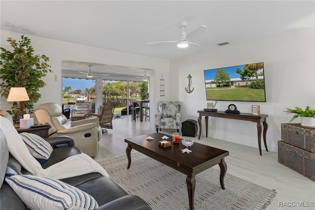 living room featuring ceiling fan and light hardwood / wood-style flooring