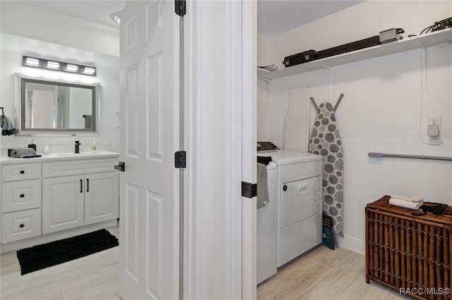 bathroom with hardwood / wood-style floors, washer and dryer, and vanity