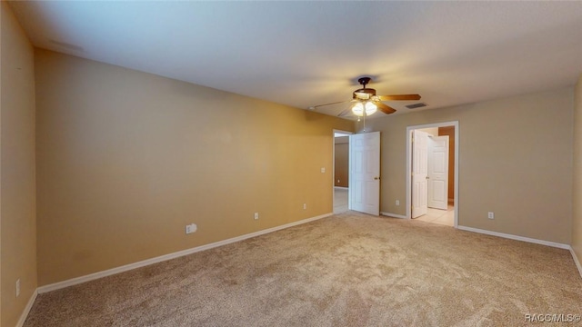 unfurnished bedroom with visible vents, ceiling fan, baseboards, light carpet, and ensuite bathroom