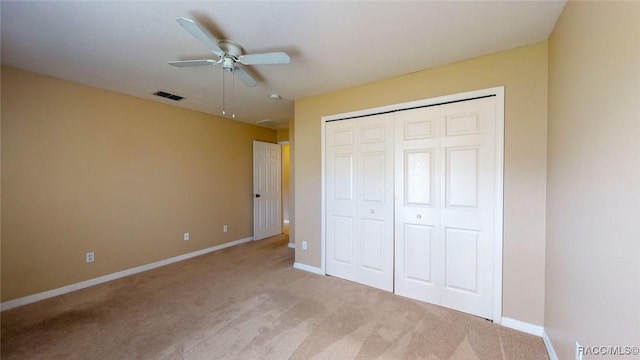 unfurnished bedroom featuring visible vents, ceiling fan, carpet, baseboards, and a closet