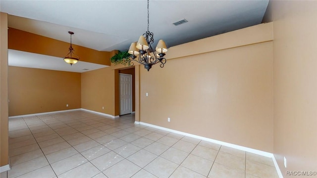 spare room featuring light tile patterned floors, visible vents, baseboards, and a chandelier