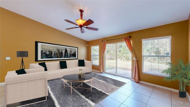 tiled living room featuring baseboards, lofted ceiling, and a ceiling fan