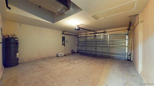 garage with water heater, a garage door opener, and electric panel