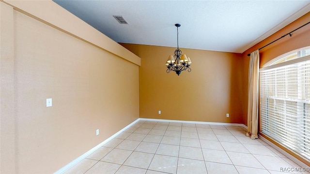 unfurnished room with light tile patterned floors, visible vents, baseboards, and an inviting chandelier