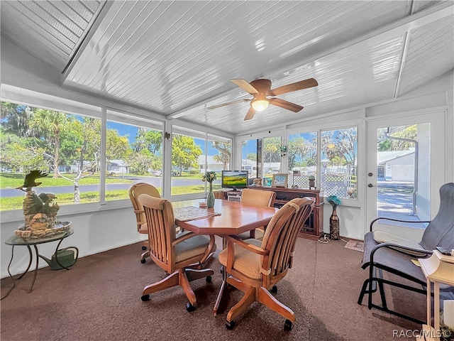 sunroom featuring ceiling fan, a healthy amount of sunlight, and lofted ceiling