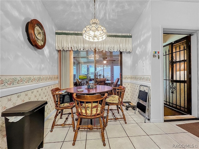 dining room featuring tile patterned floors, heating unit, and a textured ceiling