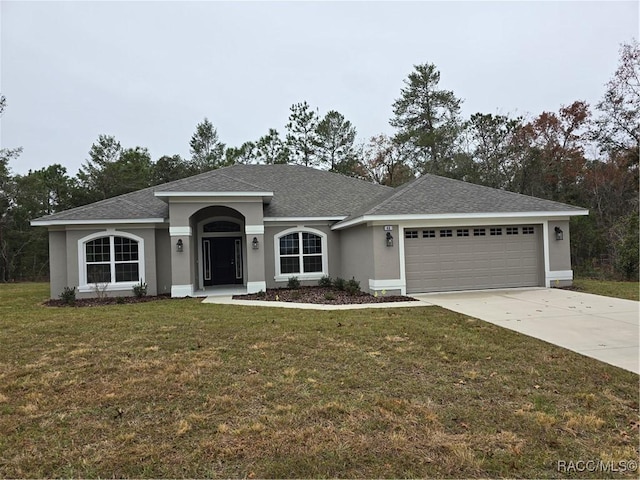 ranch-style home with a garage and a front yard