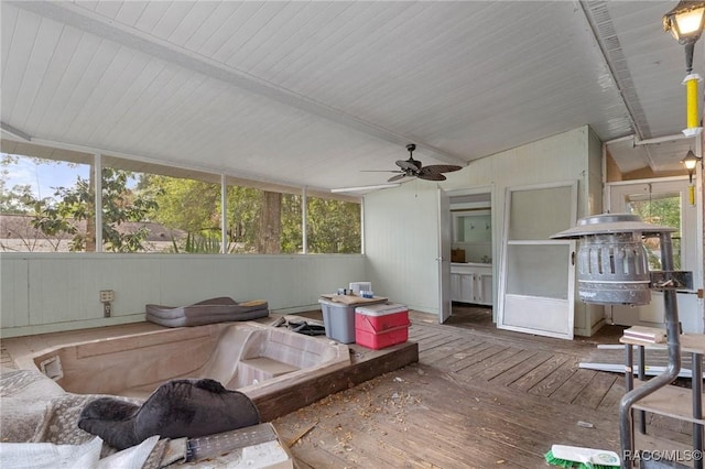 sunroom featuring vaulted ceiling and ceiling fan