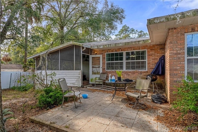 rear view of house with a patio and a sunroom