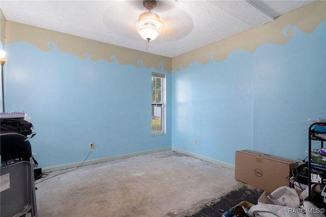 interior space with concrete floors and ceiling fan