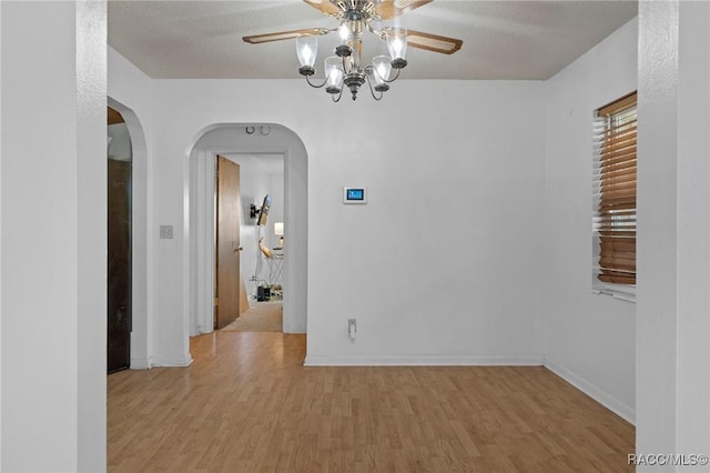 interior space featuring ceiling fan, light hardwood / wood-style floors, and a textured ceiling