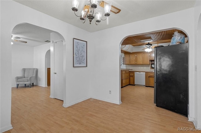 kitchen featuring dishwasher, ceiling fan with notable chandelier, stainless steel fridge, and light wood-type flooring