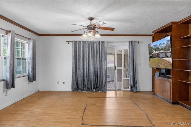 unfurnished living room featuring crown molding, light hardwood / wood-style floors, and a textured ceiling