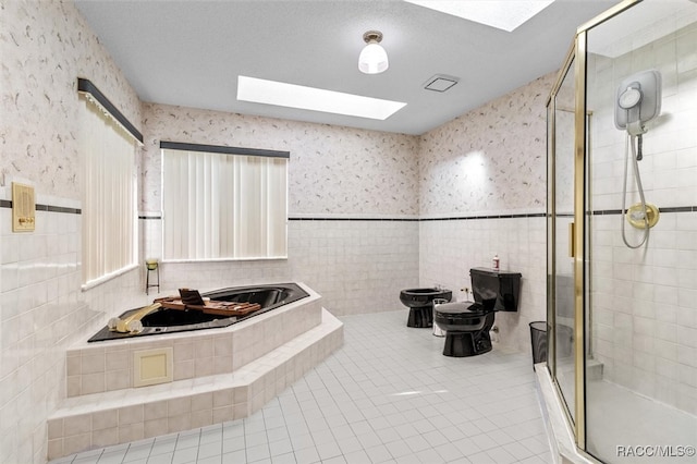 bathroom featuring a skylight, plus walk in shower, a bidet, tile patterned flooring, and toilet