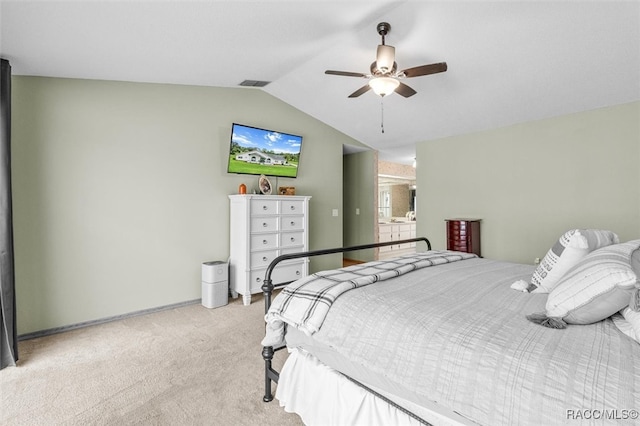 bedroom featuring light colored carpet, vaulted ceiling, and ceiling fan