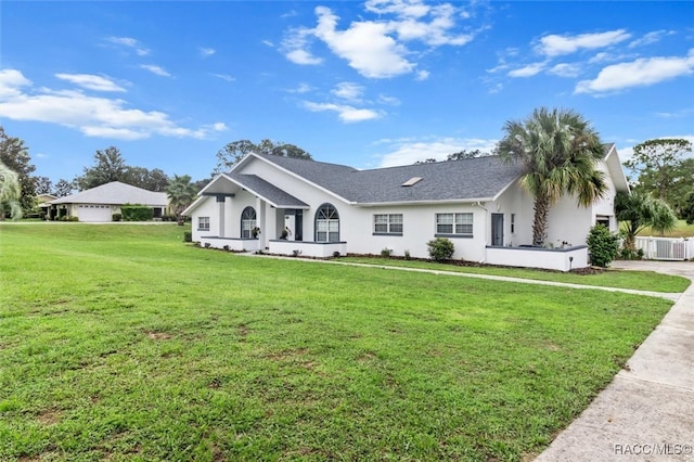 ranch-style home featuring a front yard and central air condition unit