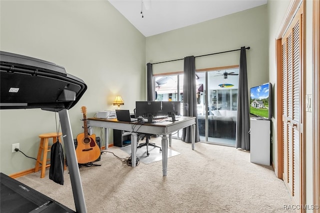 carpeted home office featuring ceiling fan and vaulted ceiling