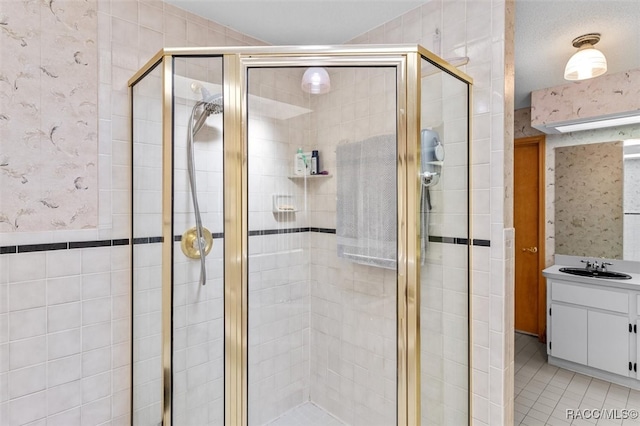 bathroom with tile patterned floors, vanity, and a shower with shower door