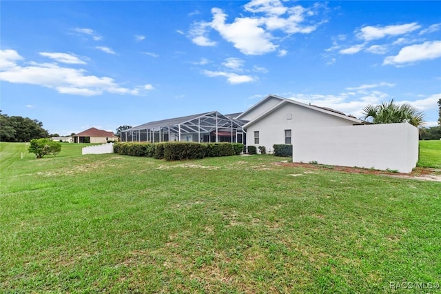 view of yard featuring glass enclosure