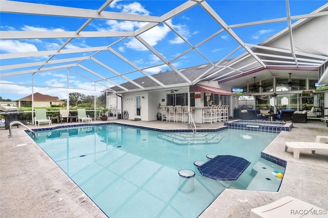 view of swimming pool featuring glass enclosure, a patio area, and exterior bar