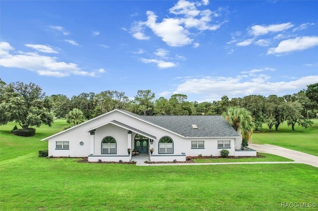 exterior space with covered porch and a front lawn