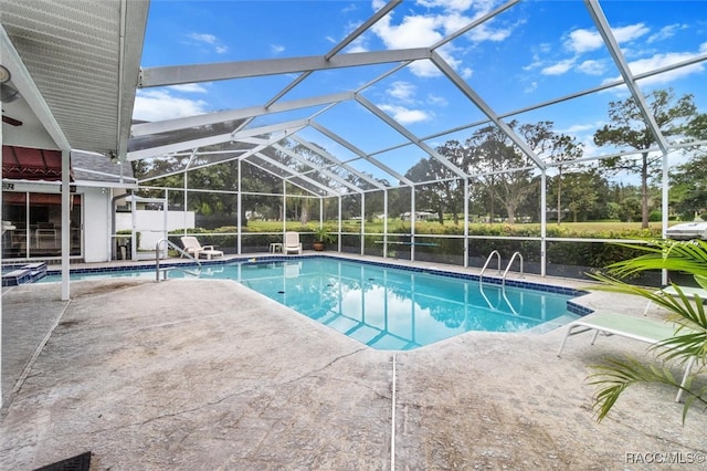 view of swimming pool with a lanai and a patio