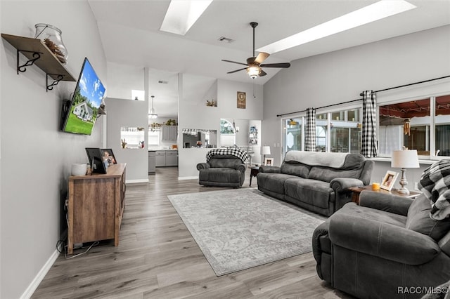 living room featuring hardwood / wood-style floors, ceiling fan, and high vaulted ceiling